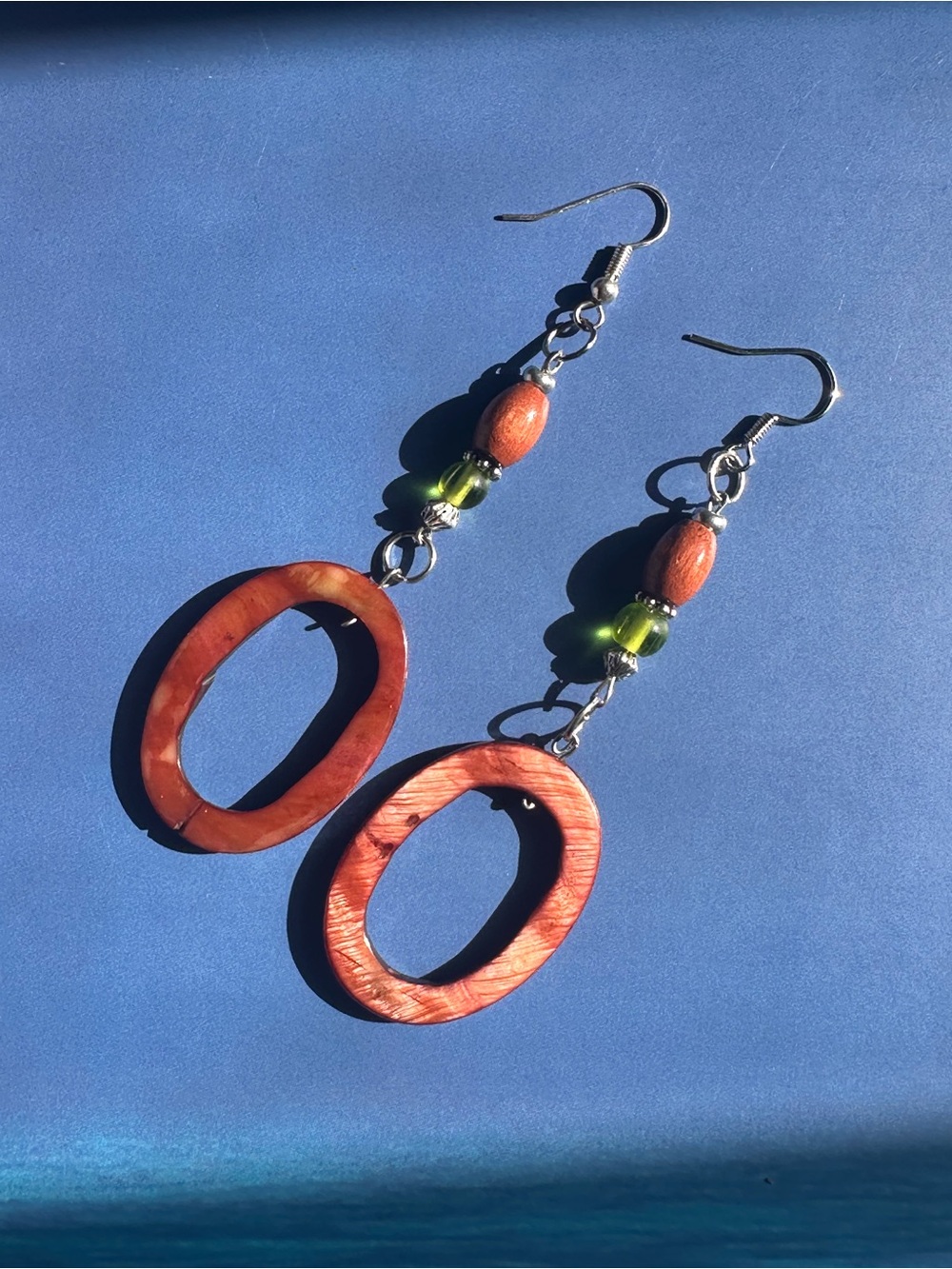 Wooden dangly earrings with green accent